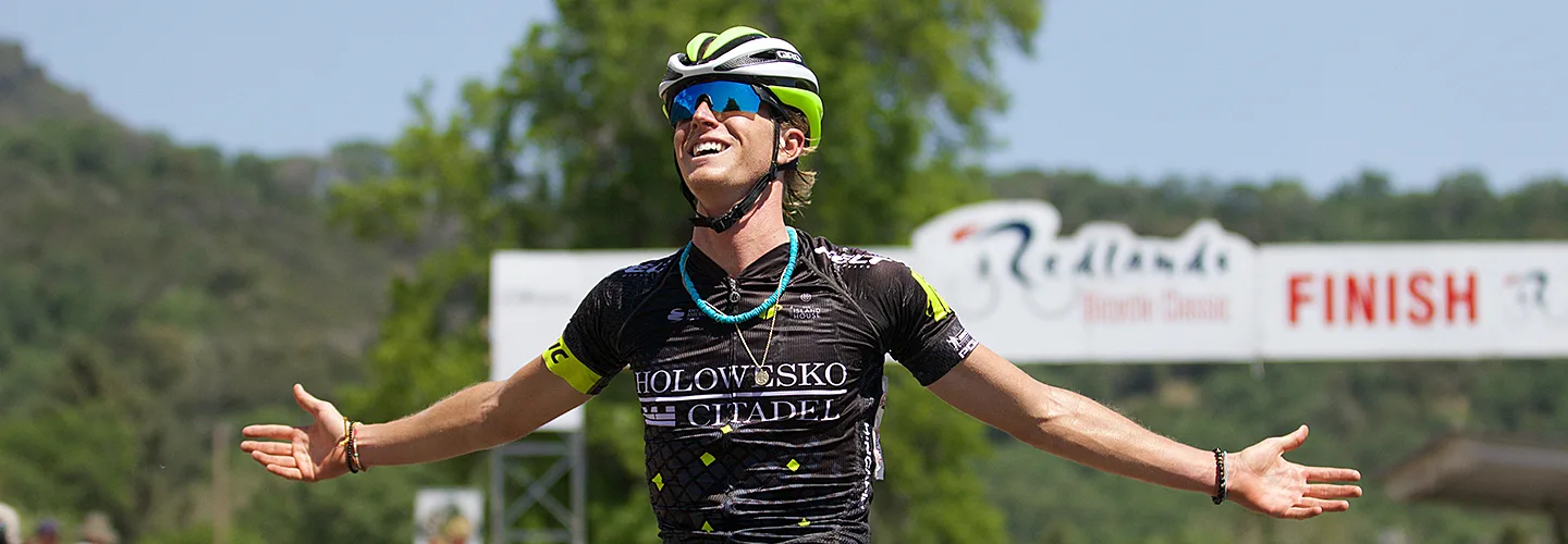Cyclist celebrating across the finish line.