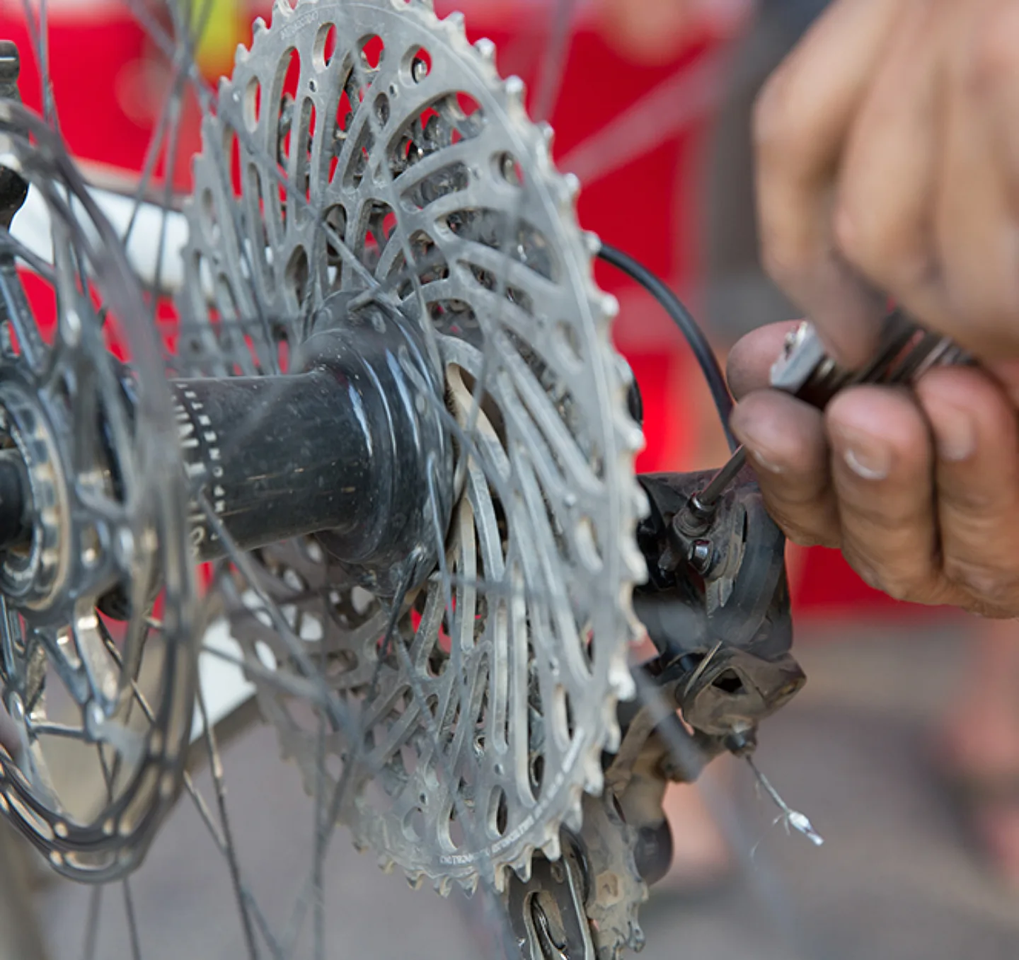 Mechanic working on a rear derailleur.