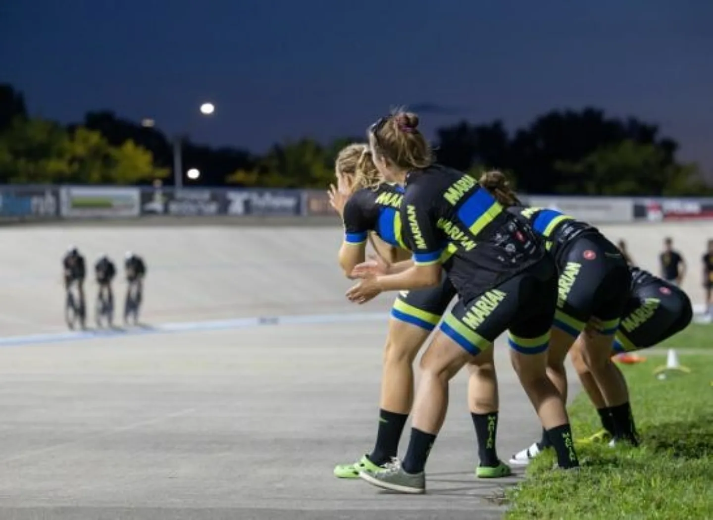 Women in bike clothing cheering on competing bikers