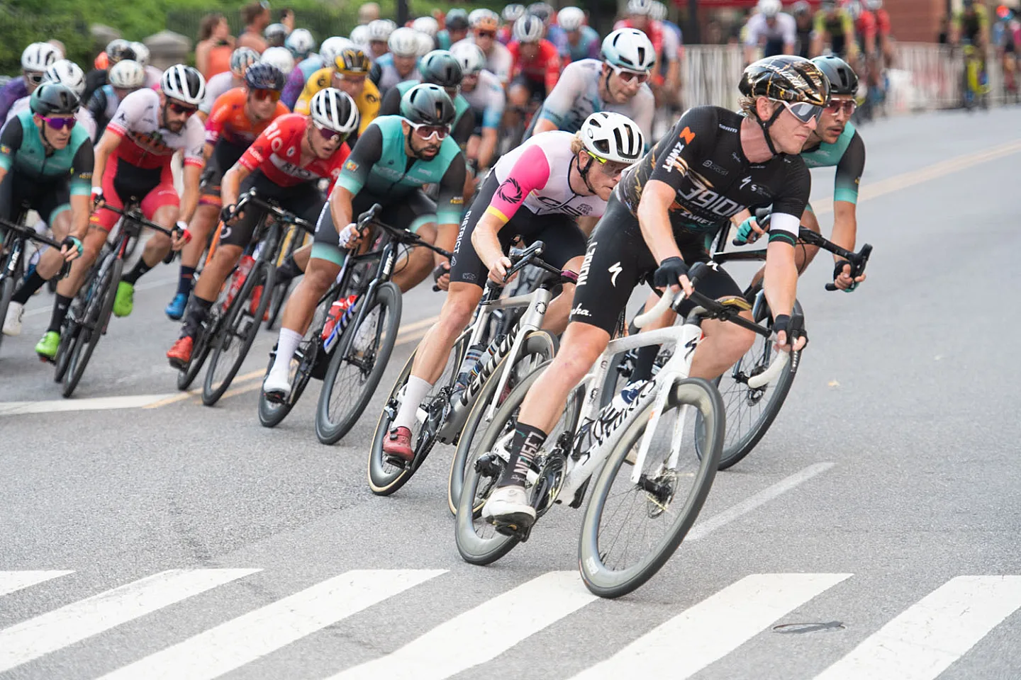 Road race with cyclists going through a corner.