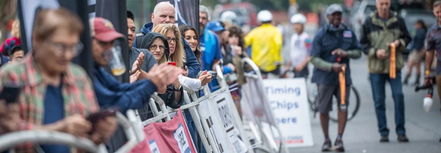 Fans lining road race.