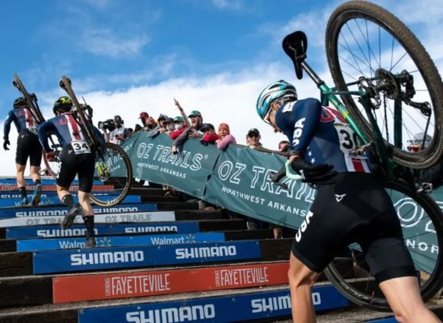 Cyclocross riders carrying their bikes up a set of stairs. The USA Cycling Foundation is a non-profit arm of USAC that raises money for several different programs and initiatives. Donate, join our foundation, or purchase cycling gear today!
