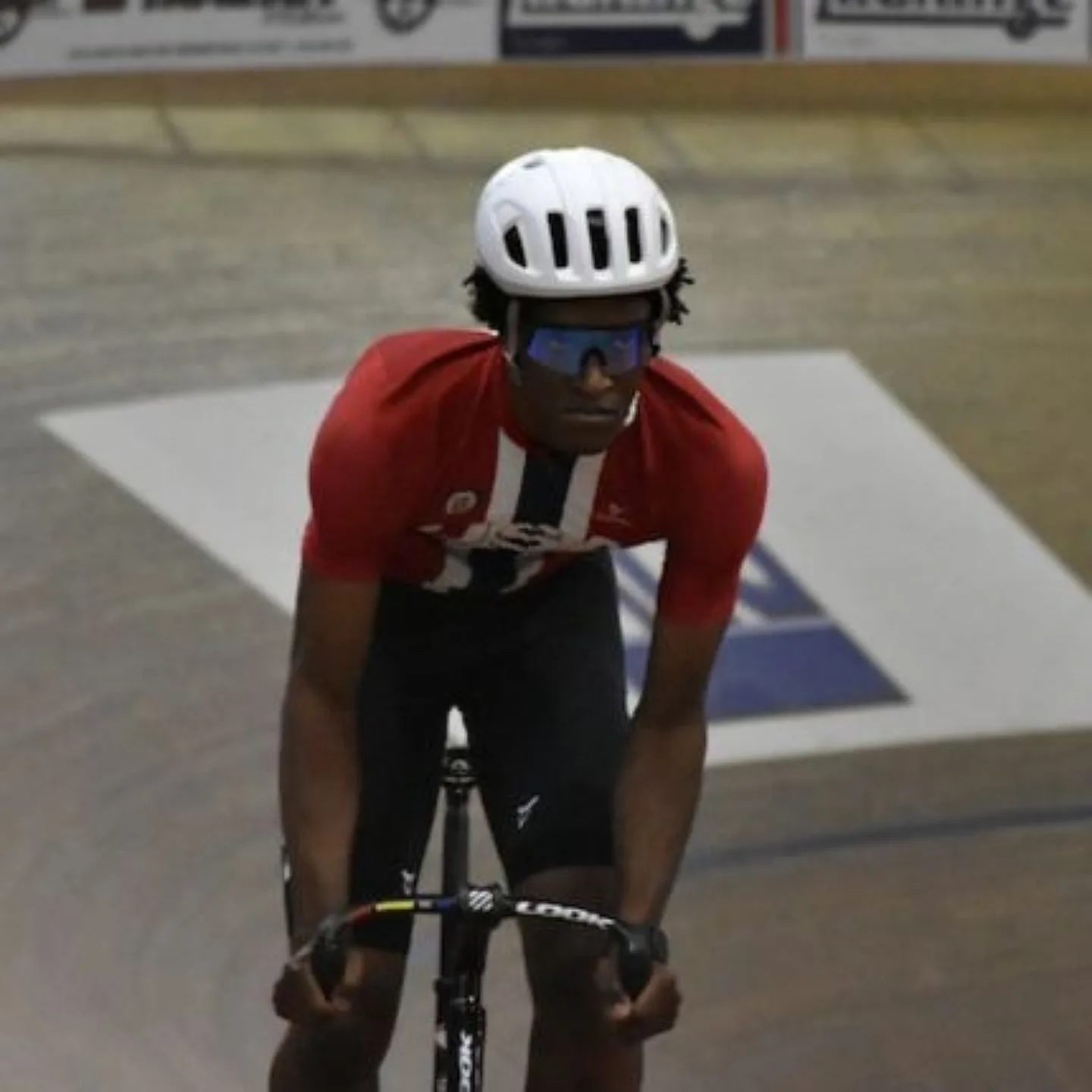 Man biking in velodrome.