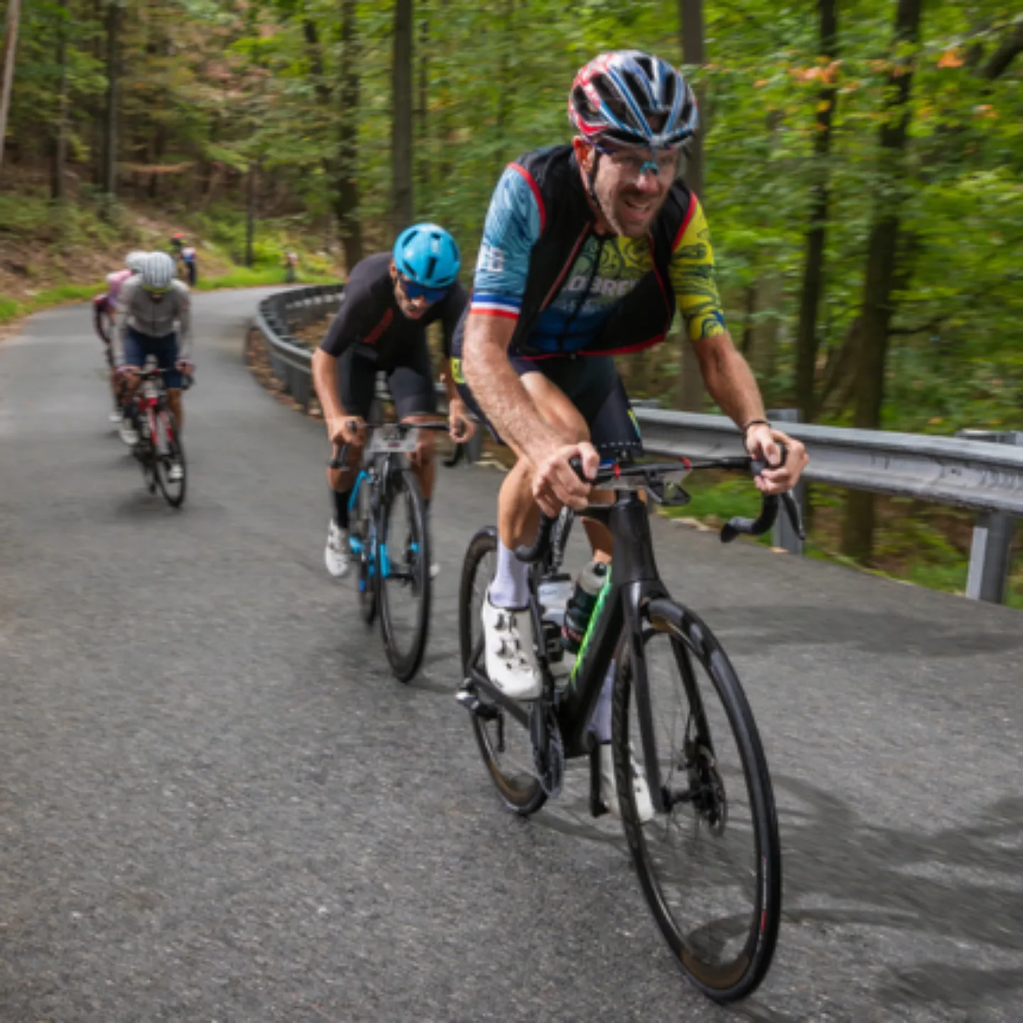 A group of road bikers climbing a steep mountain road