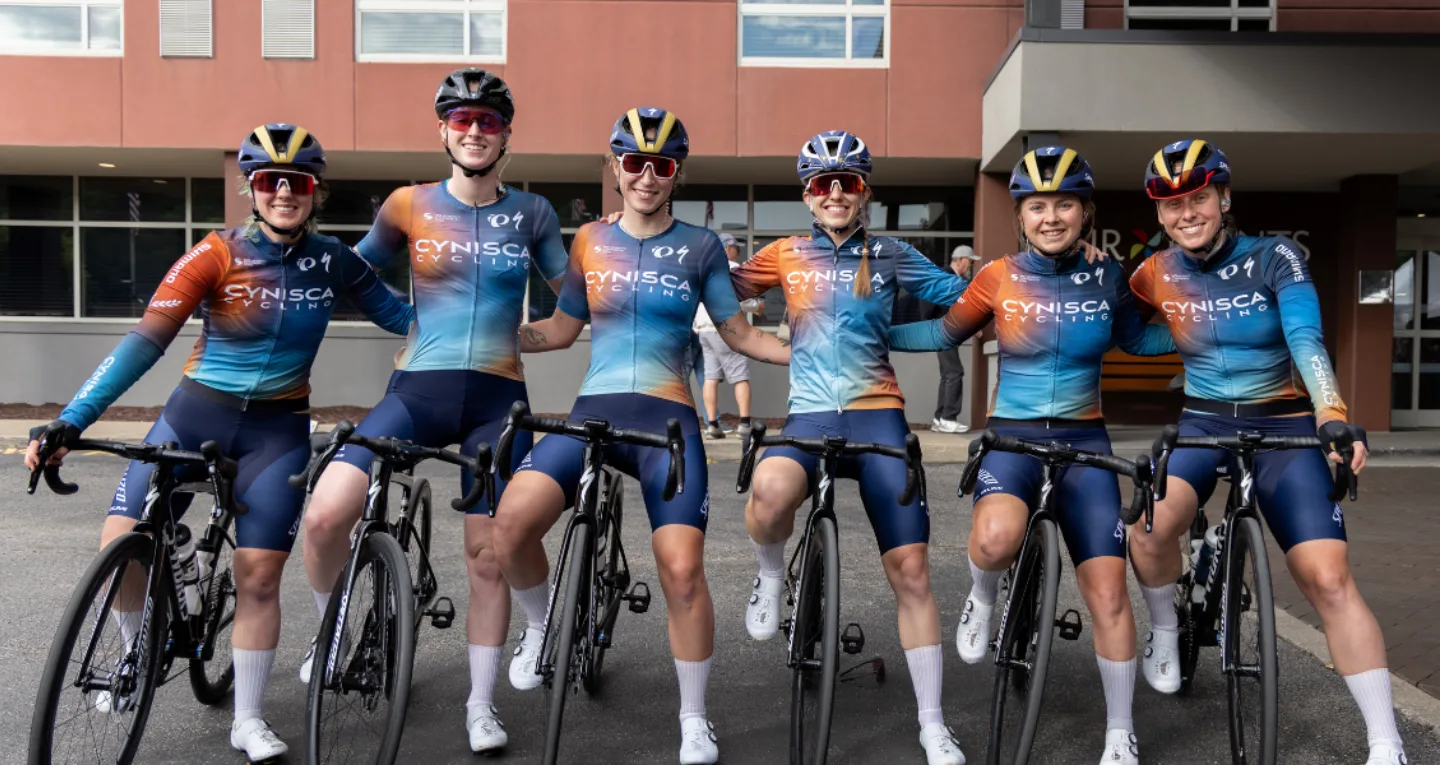 Group of female Cynsica team bike racers posing for a picture