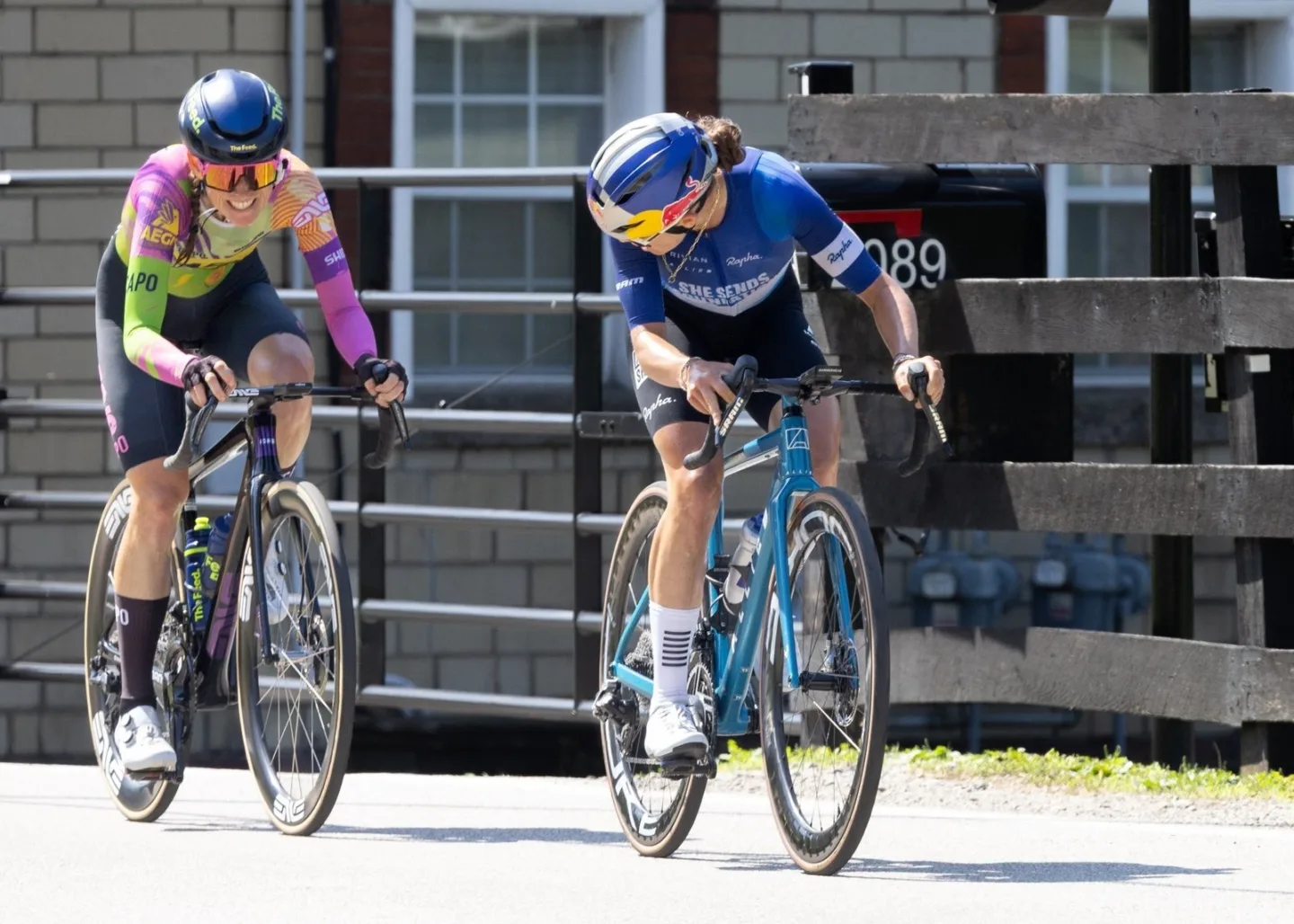 Two women cyclists racing side by side during a road race