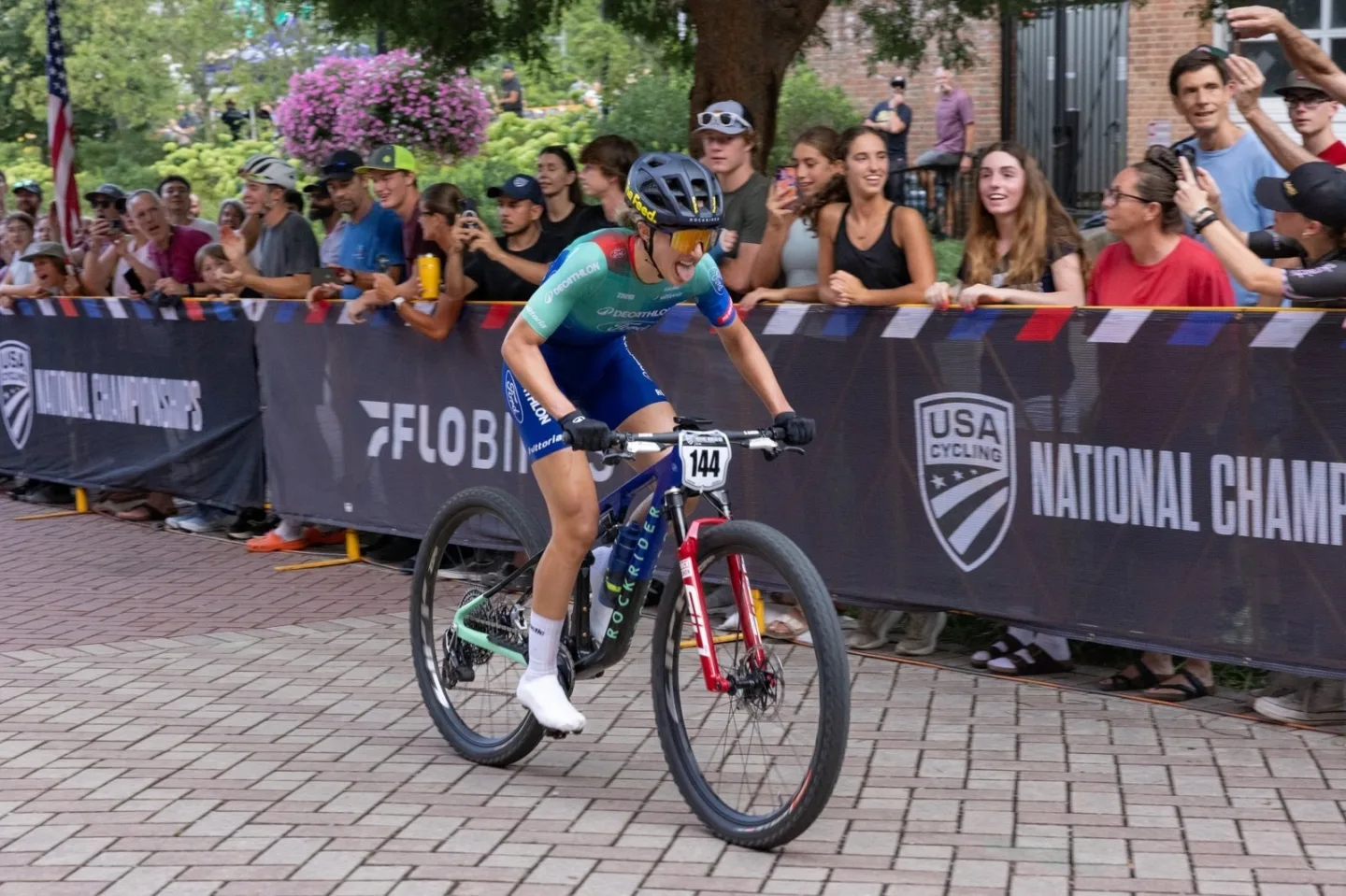 Mountain biker racing in front of cheering fans at the USA Cycling National Championships